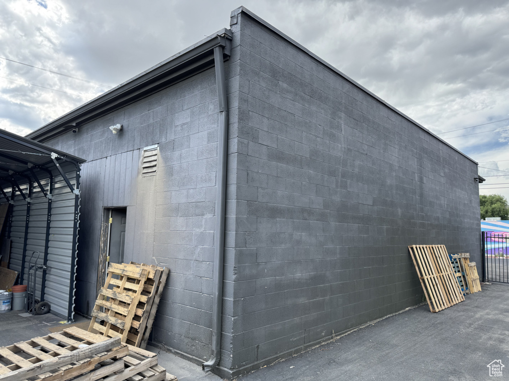 View of property exterior with concrete block siding