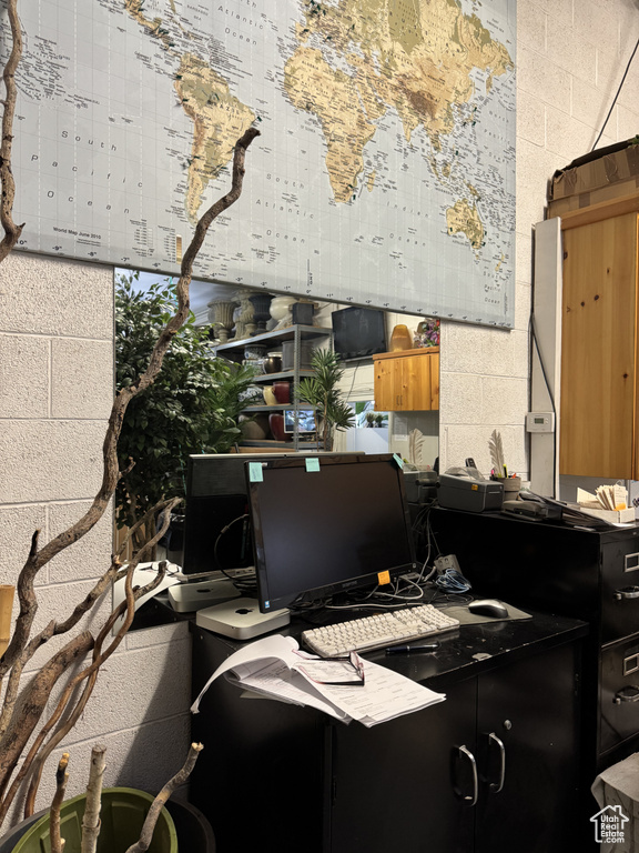 Home office with concrete block wall