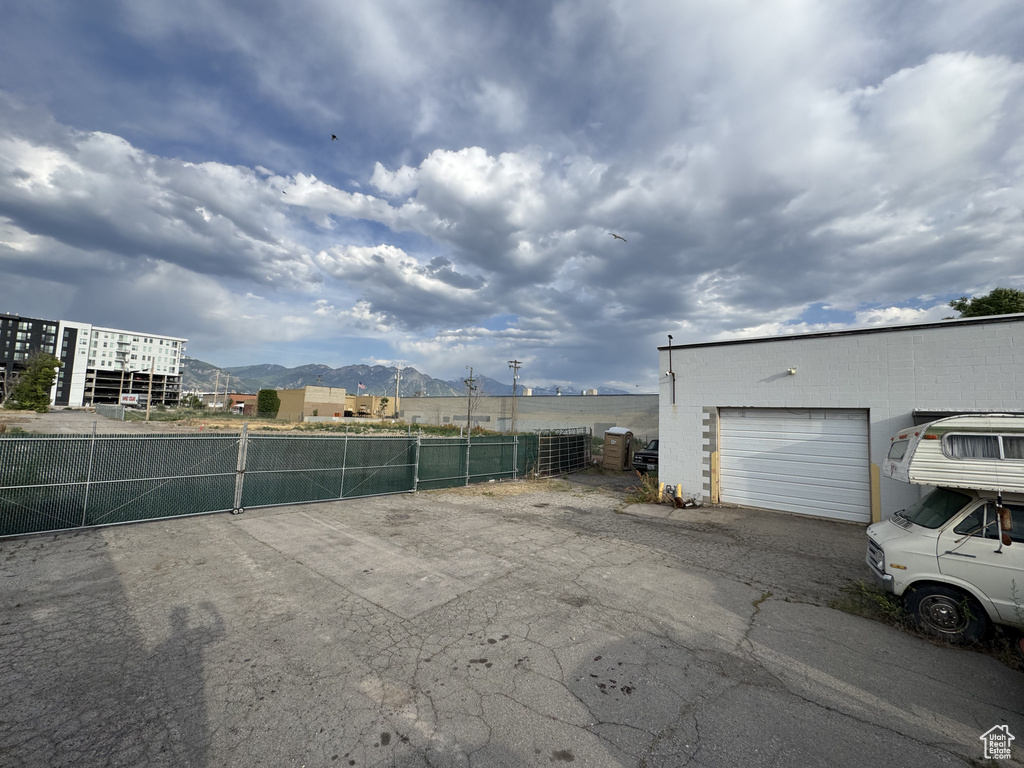 View of yard featuring a mountain view, a gate, and a garage