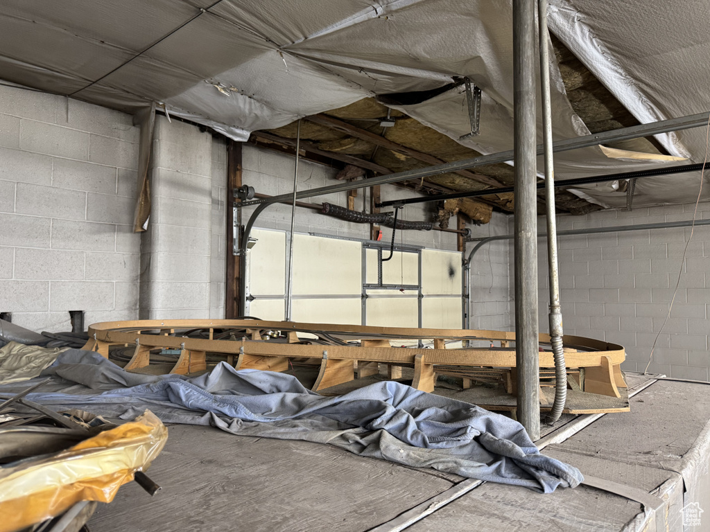 Garage featuring concrete block wall