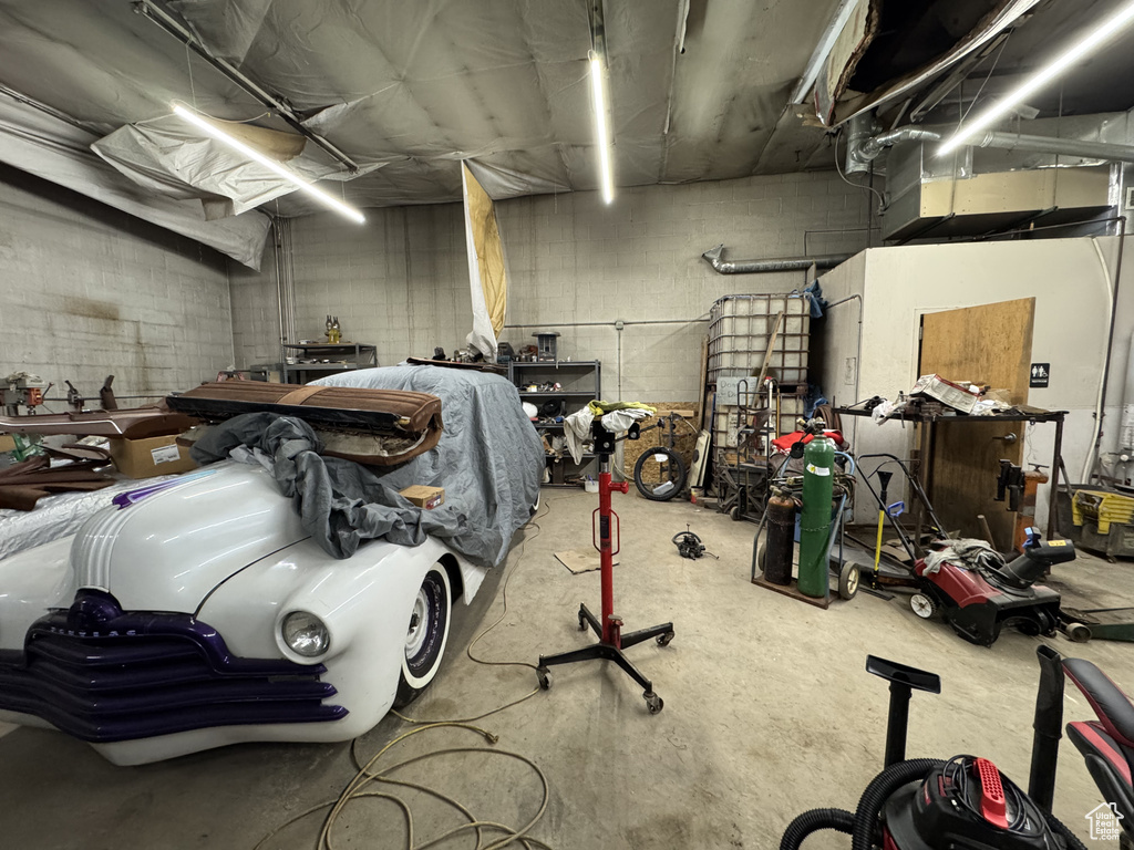 Garage featuring concrete block wall