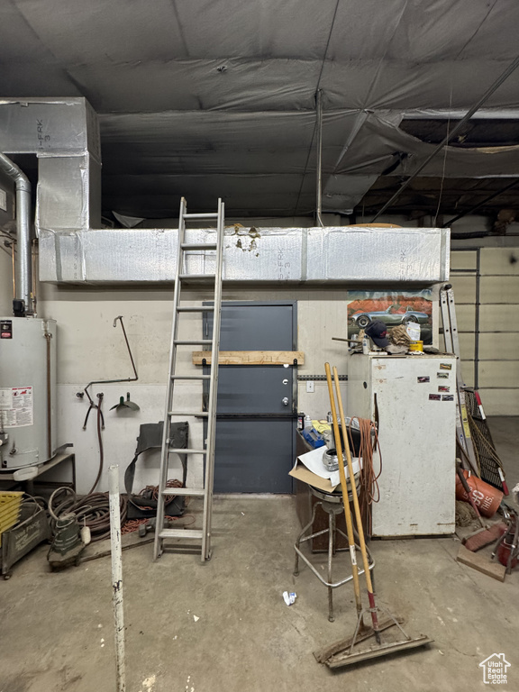 Below grade area featuring water heater