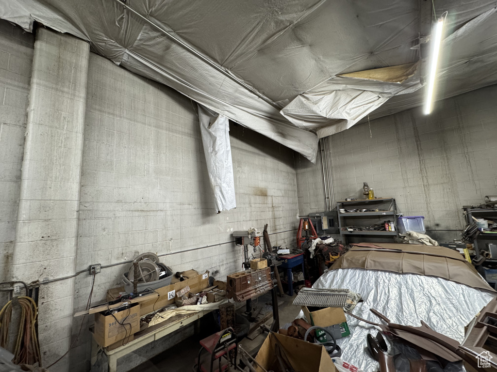 Garage featuring concrete block wall