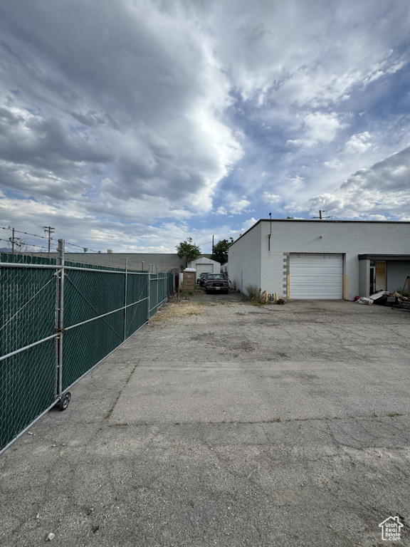 View of property exterior with driveway and an attached garage