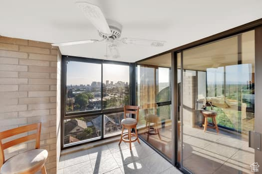 Sunroom / solarium with tile patterned flooring and expansive windows