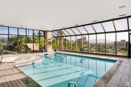 View of swimming pool featuring a pool with connected hot tub