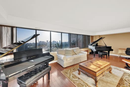 Living area with wood finished floors and baseboards