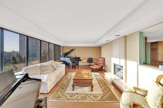 Living room featuring wood finished floors and a large fireplace