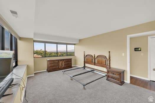 Living area featuring carpet flooring and baseboards