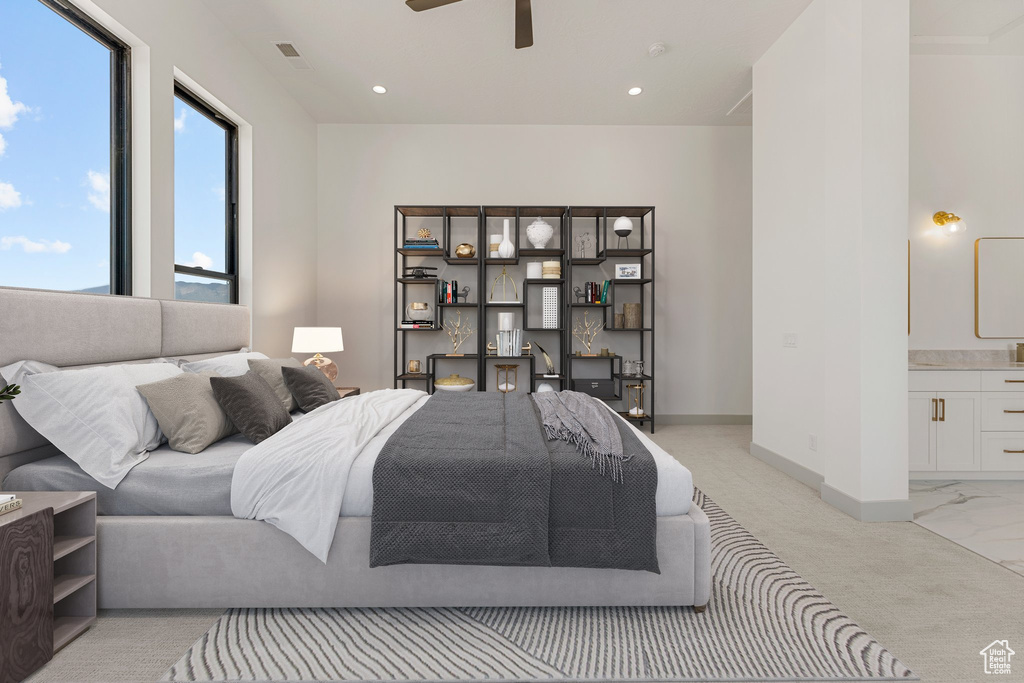 Bedroom featuring light carpet, ensuite bath, and recessed lighting