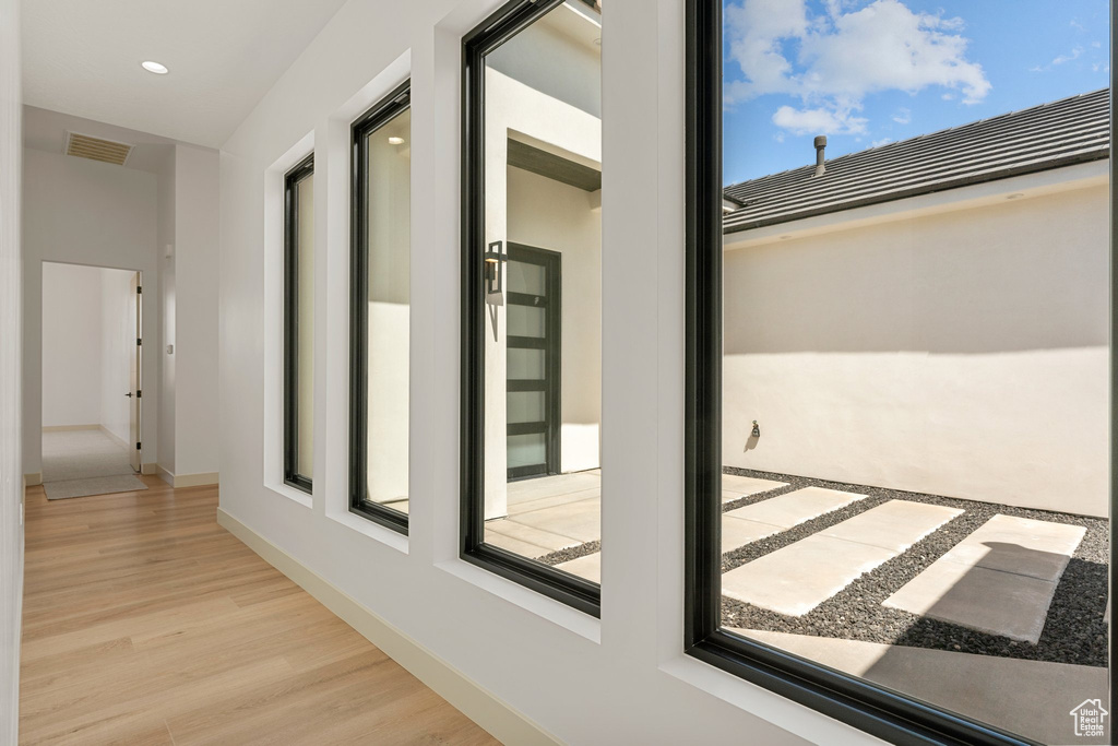 Corridor with wood finished floors and baseboards
