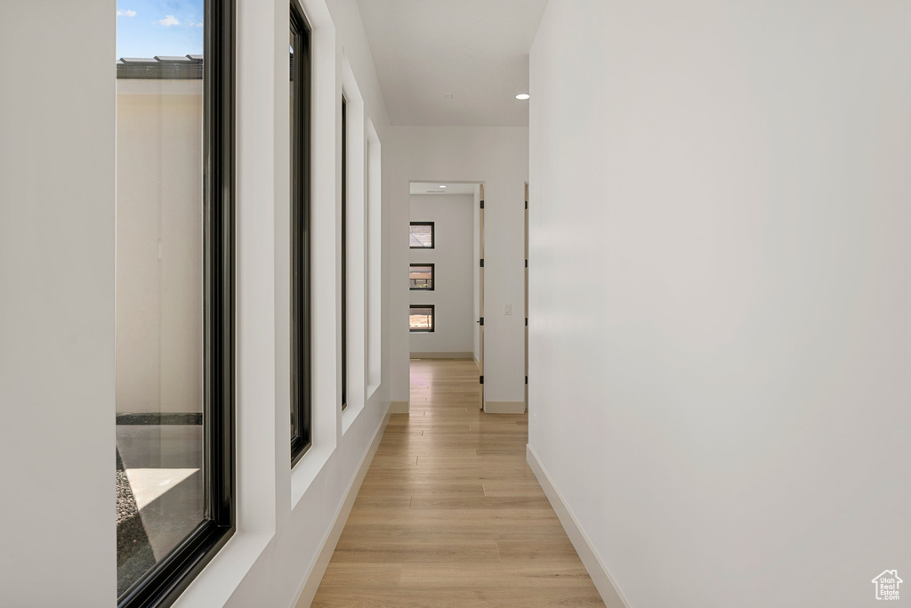 Hallway with light wood finished floors and baseboards