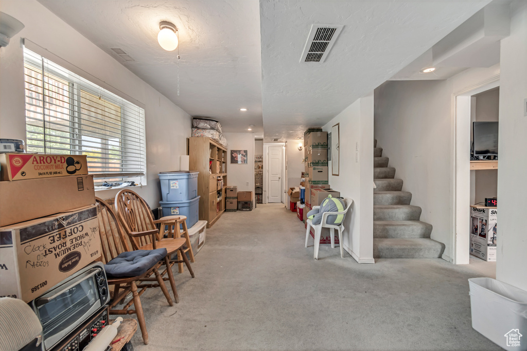 Interior space featuring carpet, healthy amount of natural light, stairway, and recessed lighting