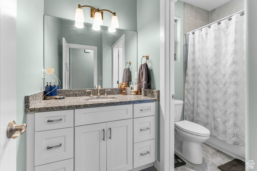 Bathroom featuring vanity and a shower with shower curtain