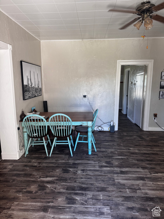 Dining space featuring wood finished floors, ceiling fan, and a textured wall