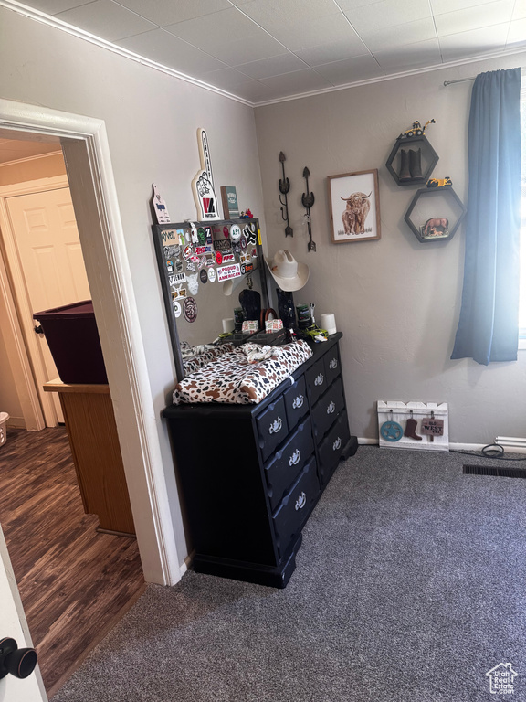 Bedroom featuring ornamental molding and carpet flooring
