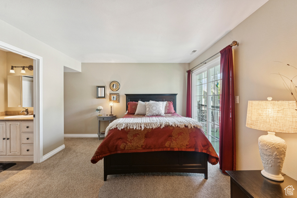 Bedroom with carpet floors and connected bathroom