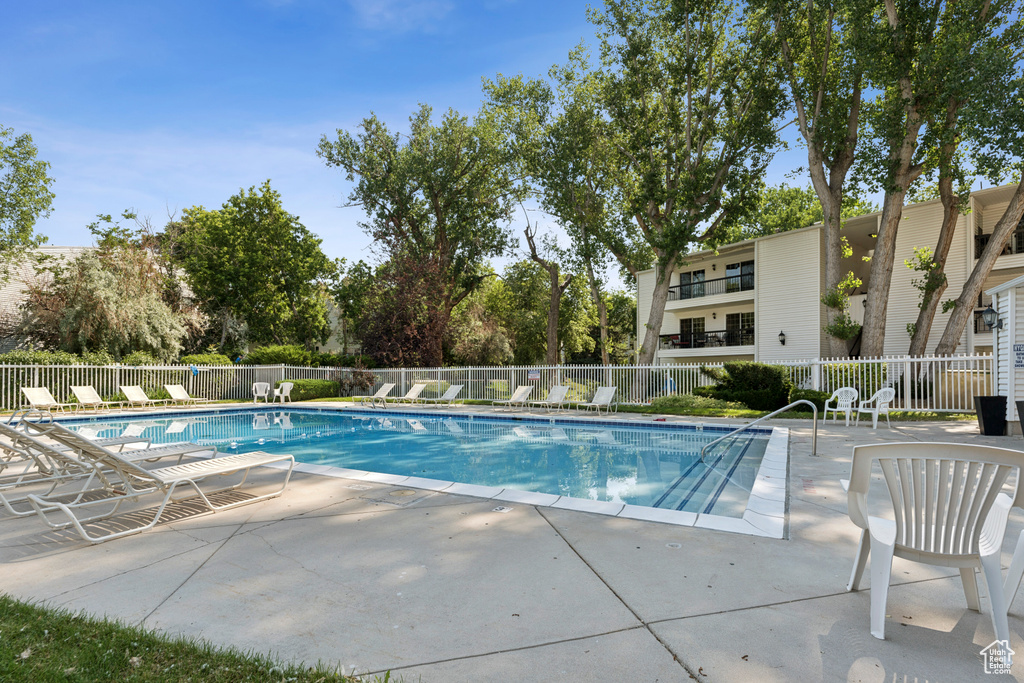 Community pool with a patio
