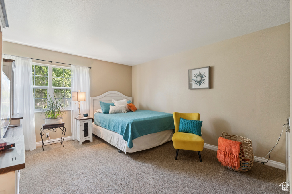 Carpeted bedroom featuring baseboards