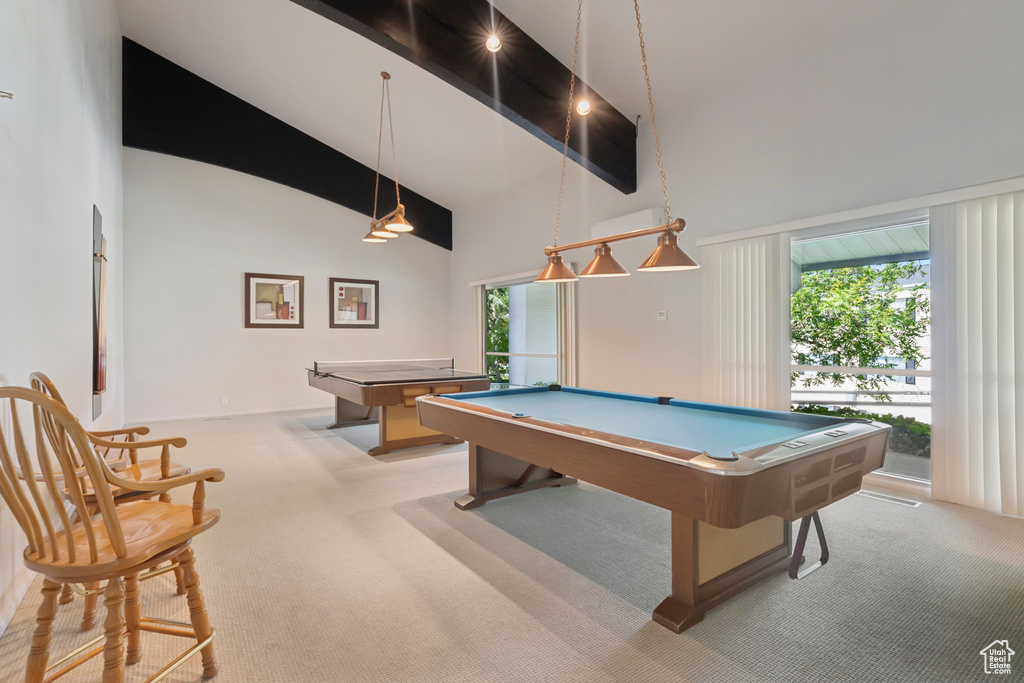 Recreation room featuring light carpet, billiards, high vaulted ceiling, and plenty of natural light