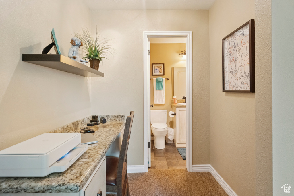 Bathroom with toilet and baseboards
