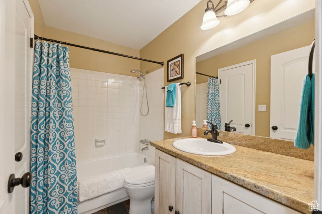Bathroom with vanity and shower / bath combination with curtain