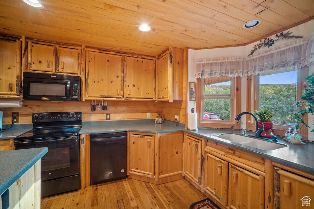 Kitchen with black appliances, wooden ceiling, light wood finished floors, recessed lighting, and dark countertops