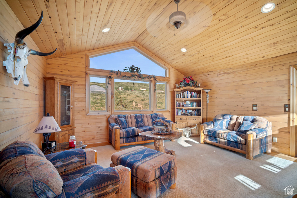 Carpeted living room with wood walls, lofted ceiling, wood ceiling, and recessed lighting
