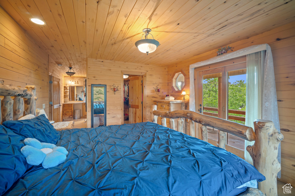 Bedroom featuring wooden walls, access to outside, and wooden ceiling