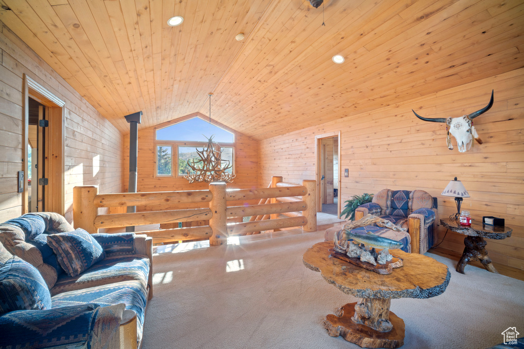 Living area featuring wooden ceiling, lofted ceiling, carpet flooring, and wooden walls