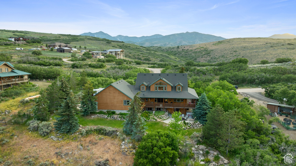 Aerial view of property and surrounding area with a mountainous background