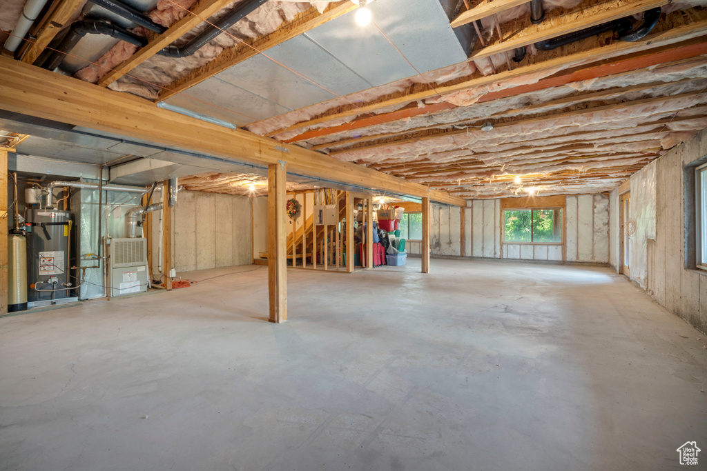 Basement featuring gas water heater and heating unit