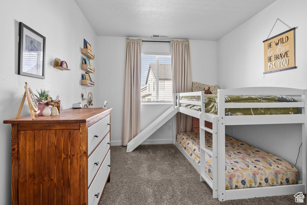 Carpeted bedroom with baseboards