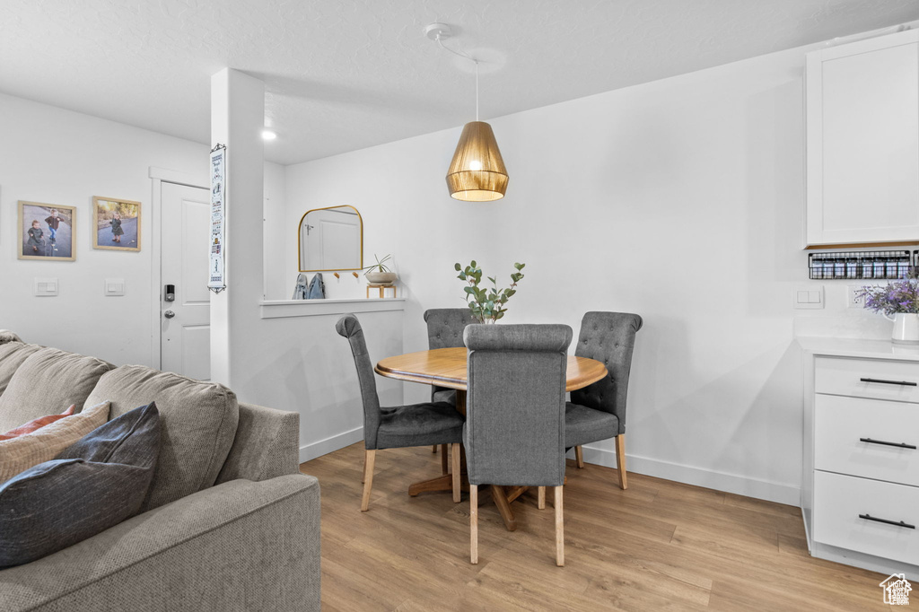 Dining space featuring baseboards and light wood-style flooring