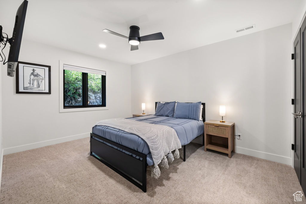Bedroom with light carpet and ceiling fan