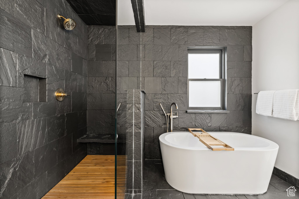 Full bathroom with a walk in shower and a soaking tub