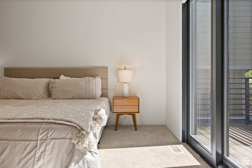 Bedroom with carpet flooring and access to outside