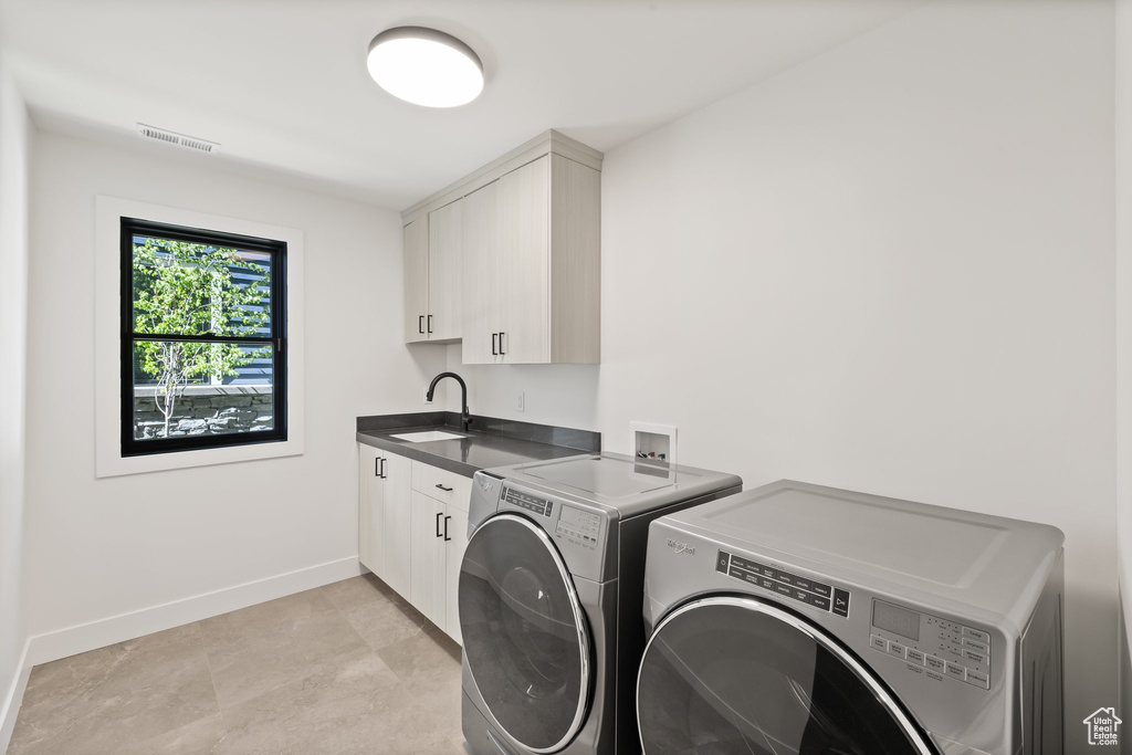 Laundry area with washing machine and dryer and cabinet space