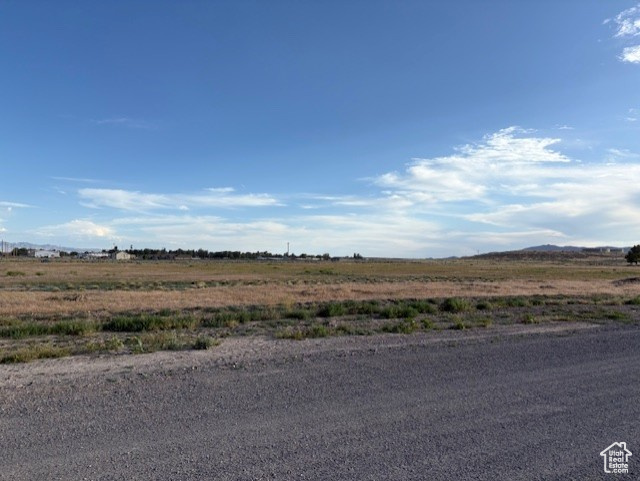 View of asphalt road featuring a view of rural / pastoral area