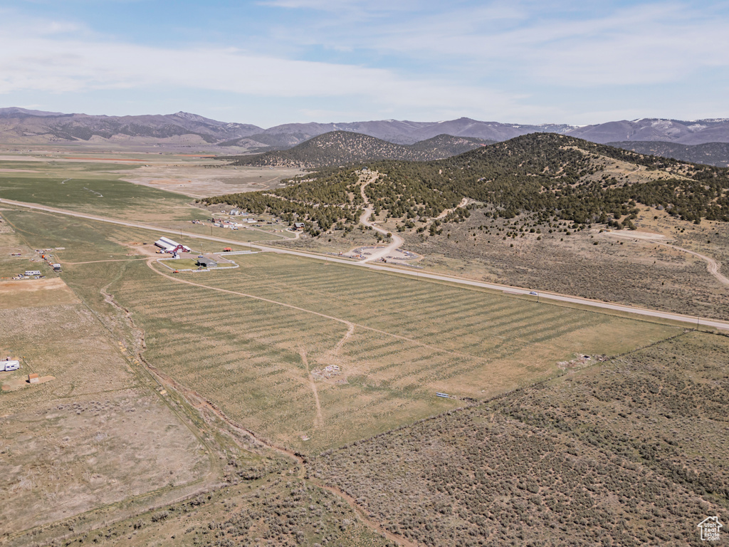 Aerial view of property's location with rural landscape and a mountainous background