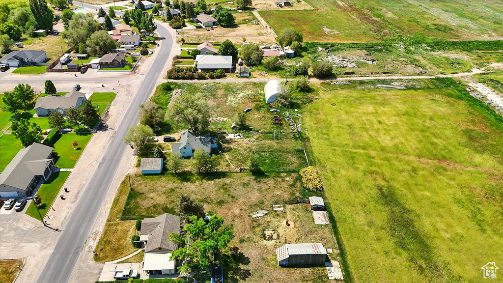 Aerial view of property and surrounding area featuring nearby suburban area