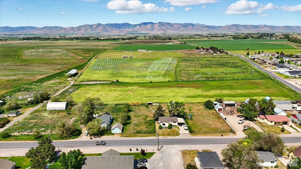 Overview of rural landscape featuring a mountainous background and abundant farmland