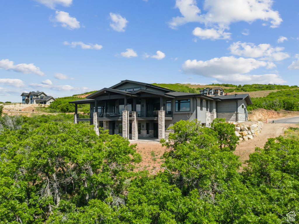 Back of house featuring a balcony