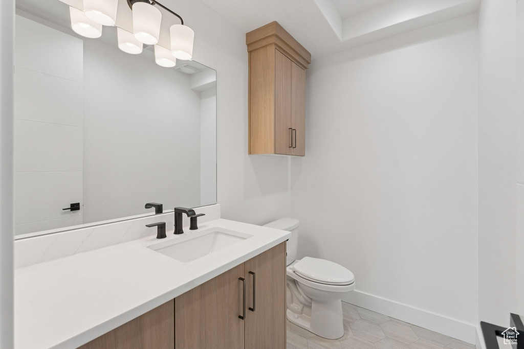 Half bathroom with toilet and vanity