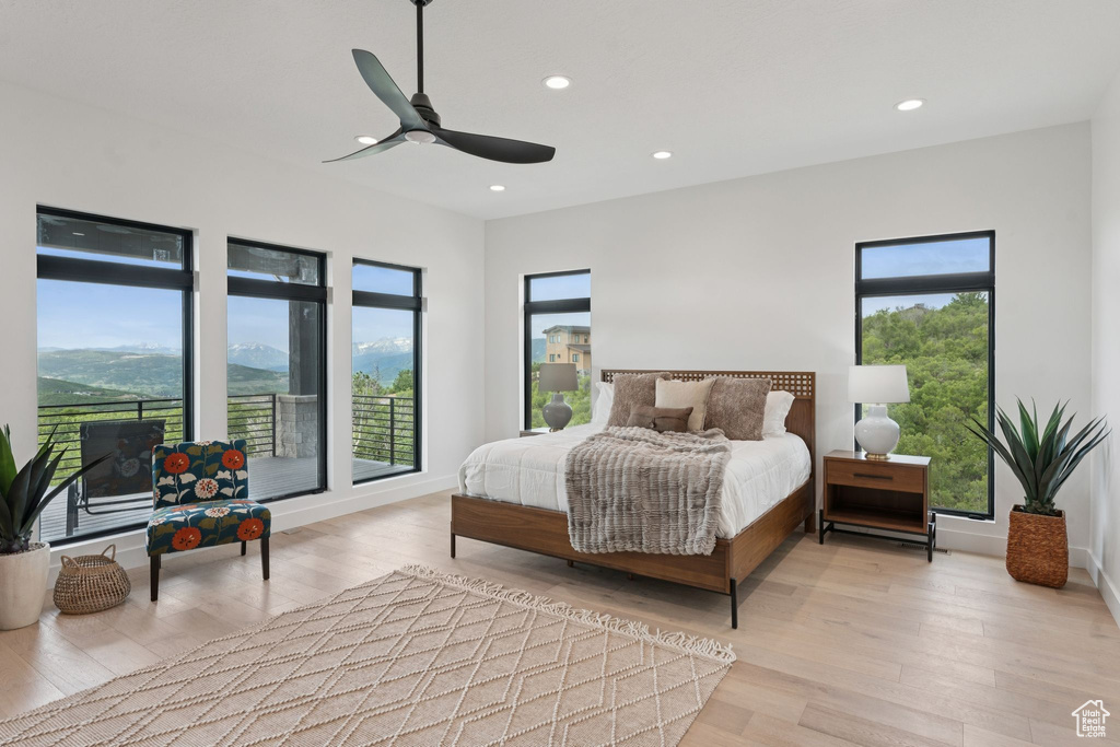 Bedroom featuring multiple windows, recessed lighting, light wood-style floors, and a ceiling fan