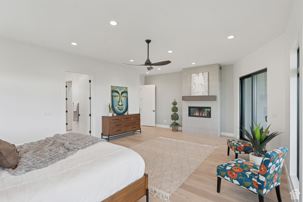 Bedroom with light wood finished floors, recessed lighting, a fireplace, and ceiling fan