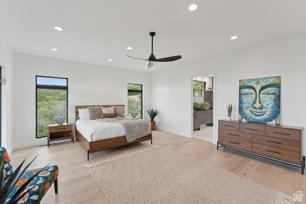 Bedroom featuring recessed lighting, light wood finished floors, ceiling fan, and ensuite bath