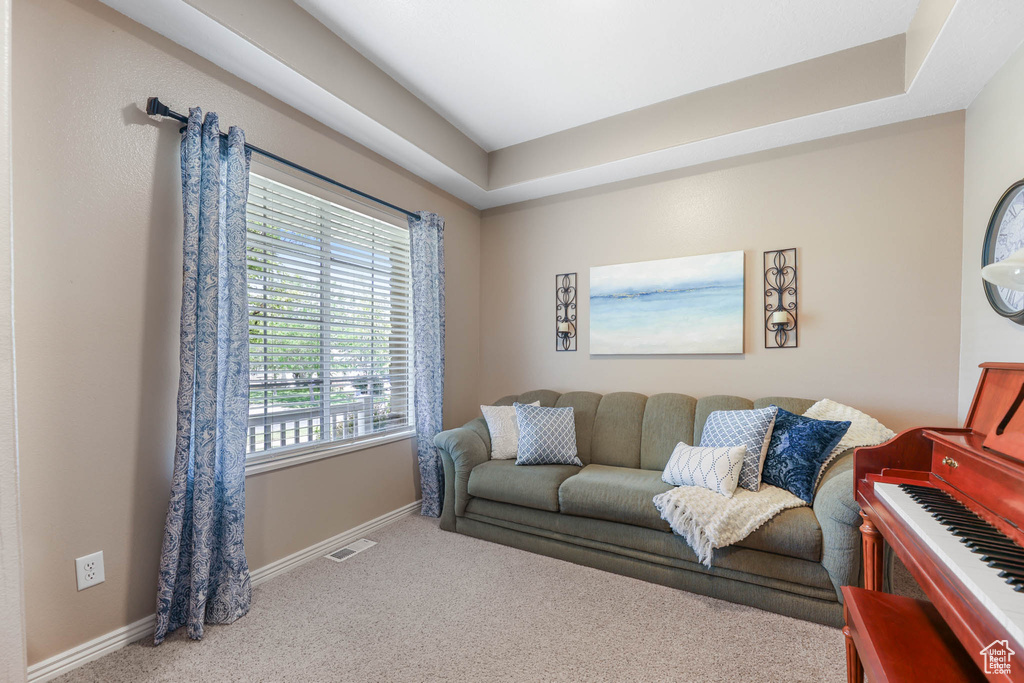 Living room with carpet flooring and baseboards