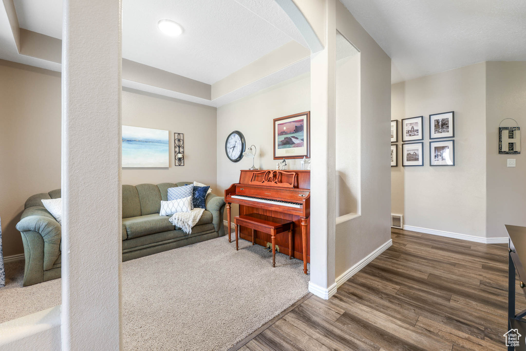 Living area with wood finished floors and arched walkways