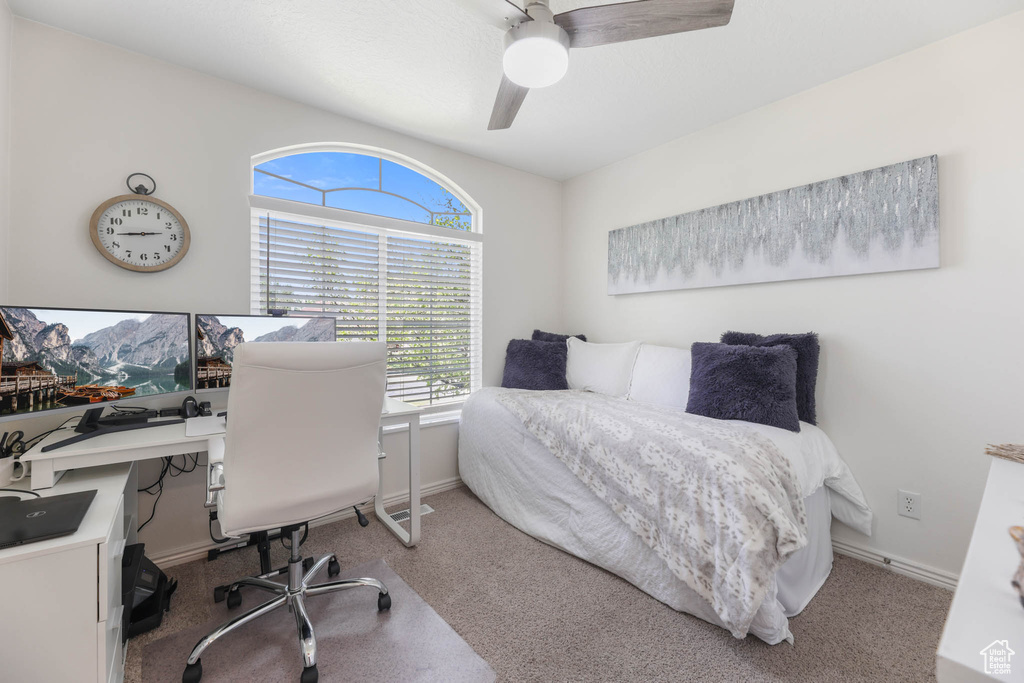 Bedroom featuring a desk, a ceiling fan, and carpet